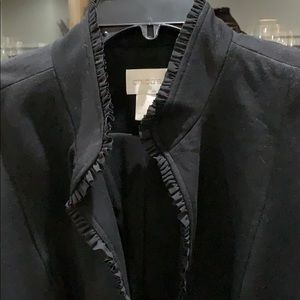 Black stretch knit blazer with collar details.